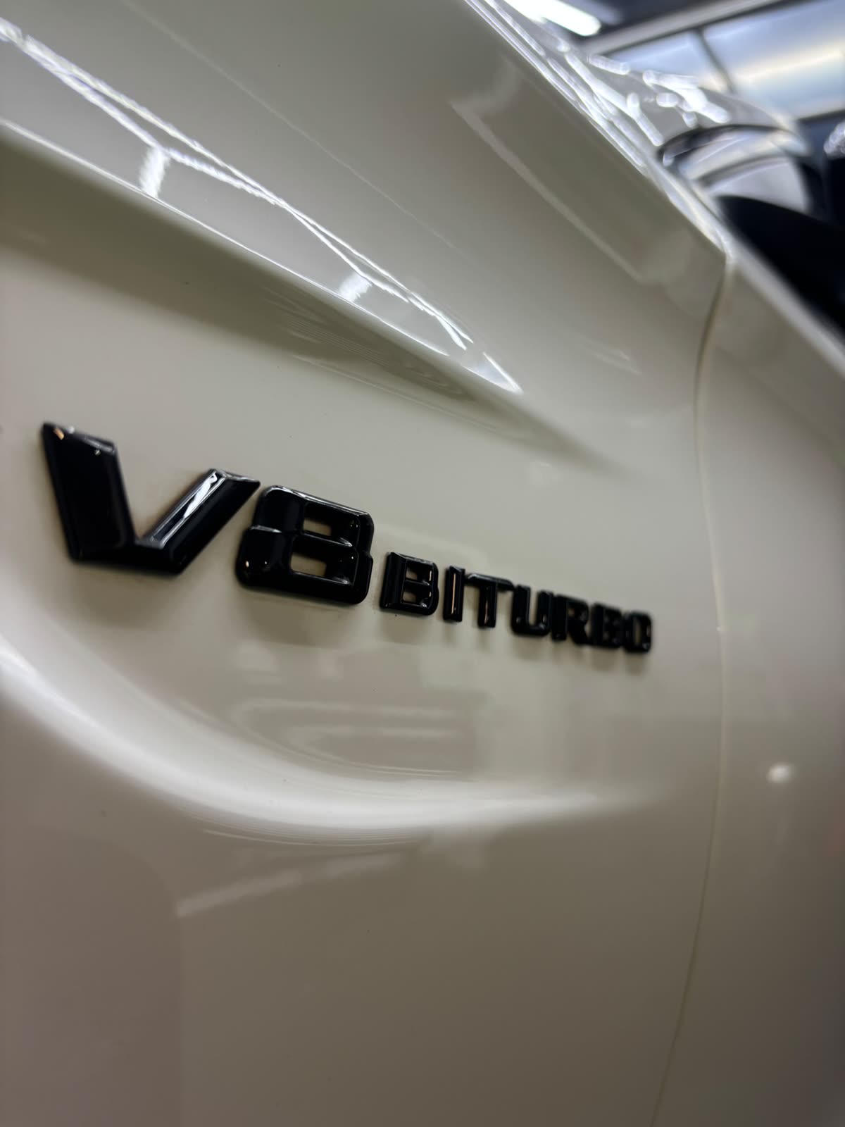 Schriftzug V8 Biturbo auf dem makellos polierten weißen Kotflügel
